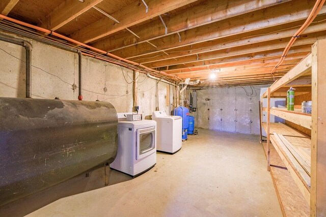 basement featuring washer and dryer and electric panel