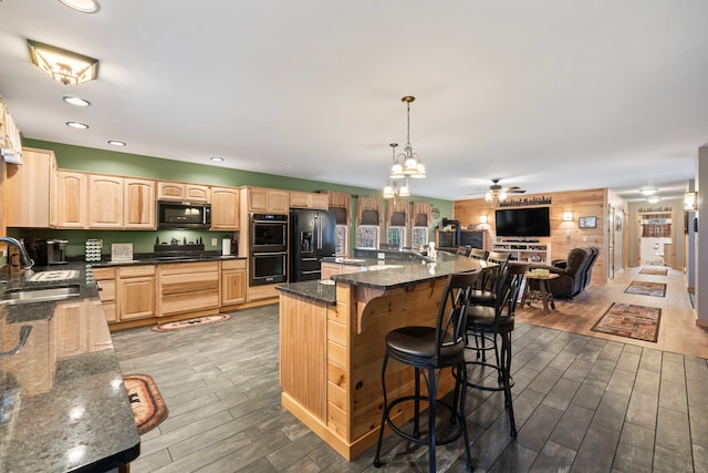 kitchen featuring ceiling fan with notable chandelier, black appliances, sink, dark hardwood / wood-style floors, and light brown cabinets