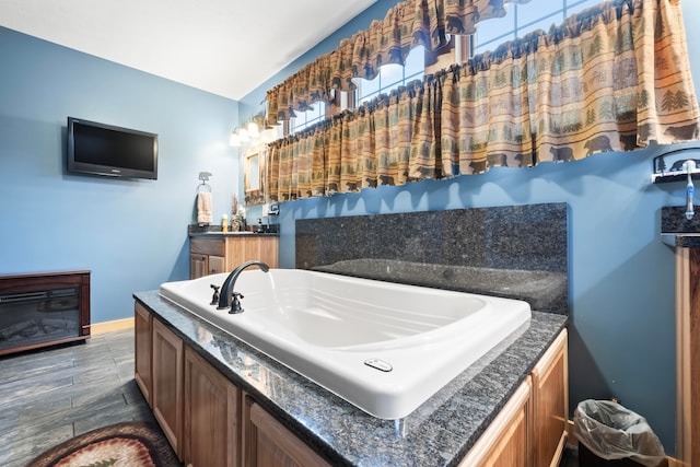 bathroom featuring hardwood / wood-style floors, vanity, and a bathing tub