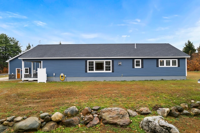 rear view of property featuring a yard