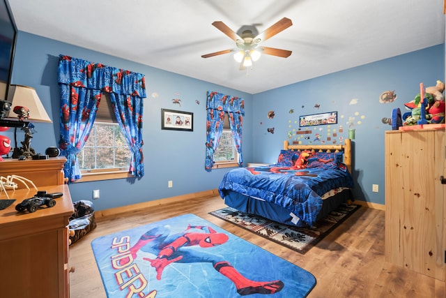 bedroom with ceiling fan and wood-type flooring