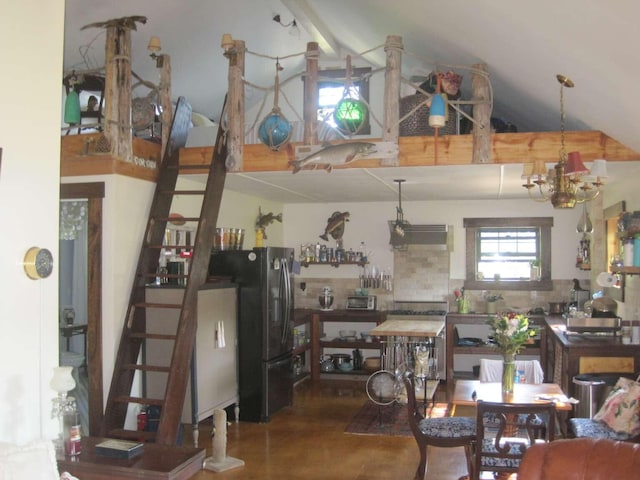 kitchen with decorative backsplash, high vaulted ceiling, and freestanding refrigerator