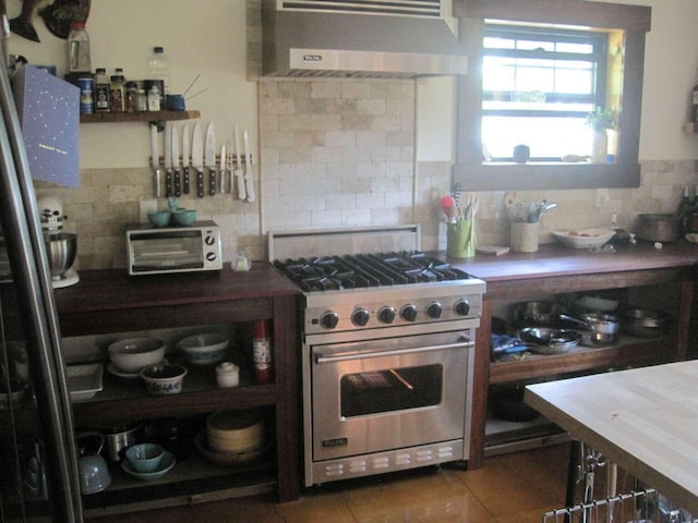 kitchen with backsplash, ventilation hood, a toaster, tile patterned floors, and high end stainless steel range