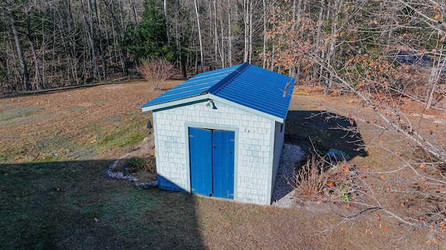 view of outbuilding featuring a yard