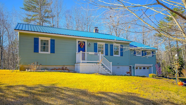 view of front of home with a front yard and a garage