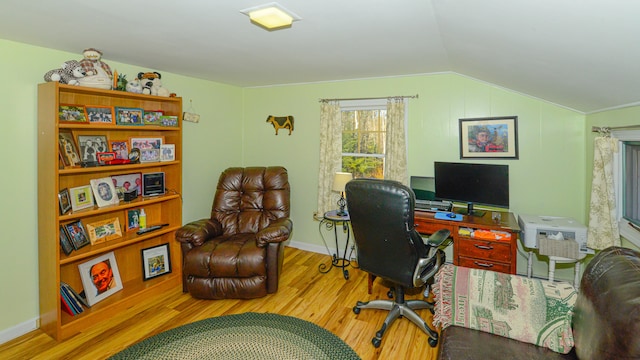 home office featuring hardwood / wood-style flooring and lofted ceiling