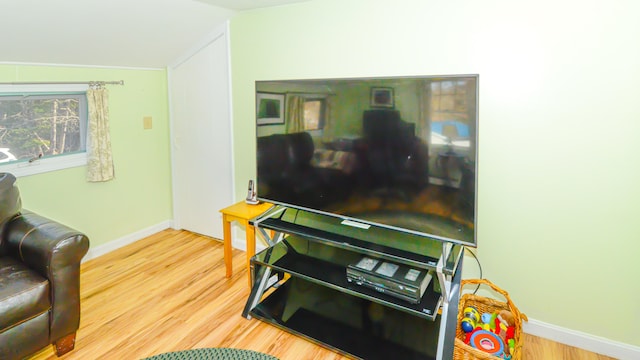 living room with hardwood / wood-style flooring and vaulted ceiling