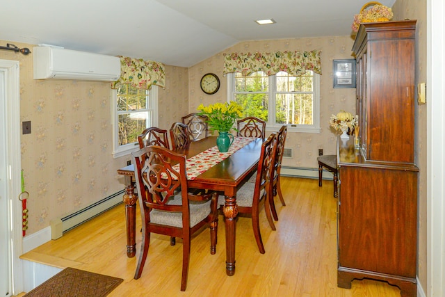 dining space with a wall mounted air conditioner, lofted ceiling, baseboard heating, and light hardwood / wood-style flooring