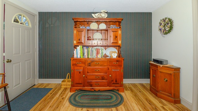 living area featuring light hardwood / wood-style floors and a textured ceiling