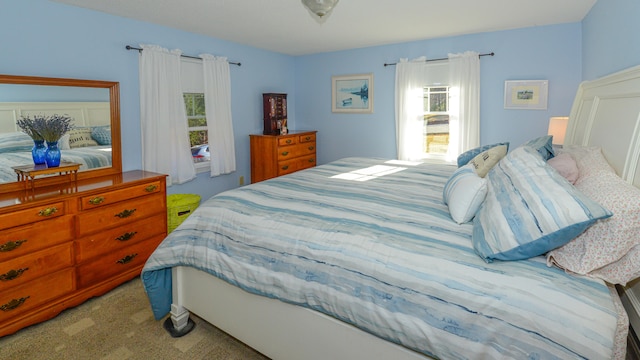 bedroom featuring light carpet