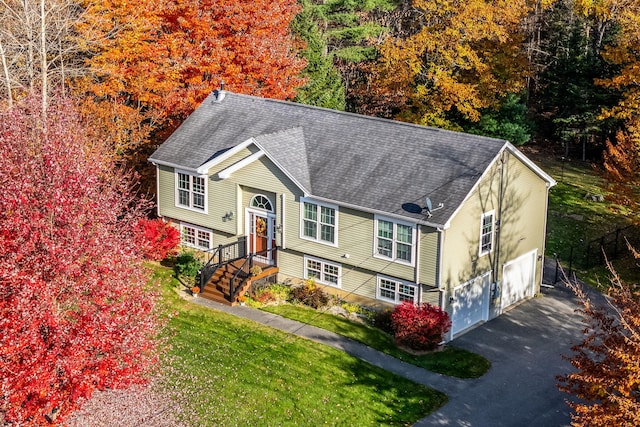 view of front of home with a garage and a front lawn