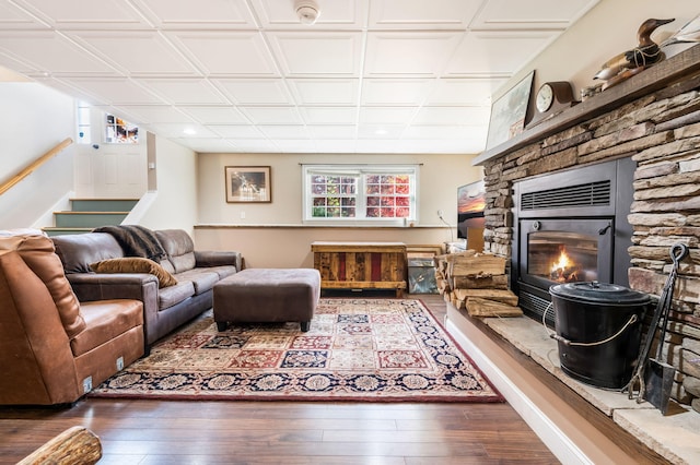 living room with a fireplace, plenty of natural light, and dark hardwood / wood-style floors