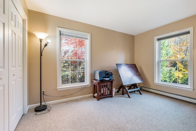 miscellaneous room with baseboard heating and light carpet