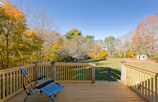 deck with a shed and a yard