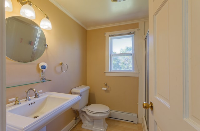 bathroom featuring wood-type flooring, crown molding, sink, a baseboard heating unit, and toilet