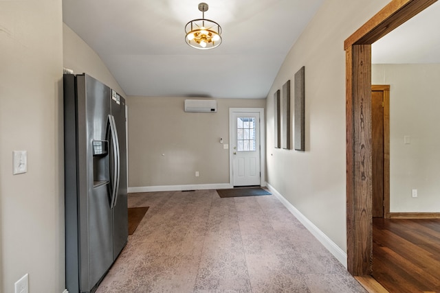 interior space with a wall unit AC, hardwood / wood-style flooring, and vaulted ceiling