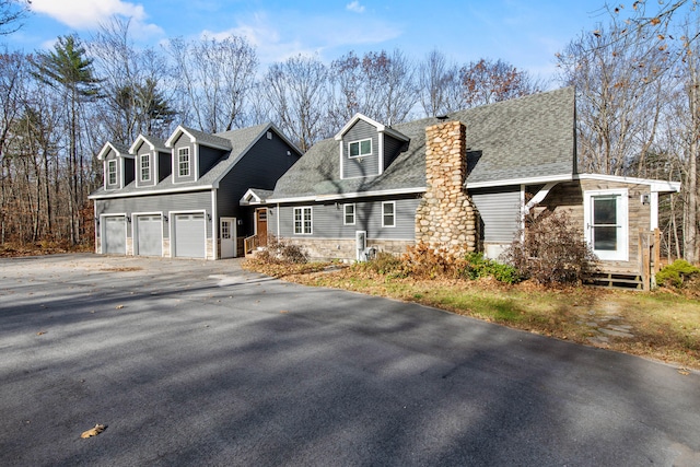 new england style home featuring a garage