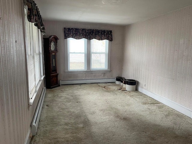 empty room featuring a baseboard radiator and carpet floors