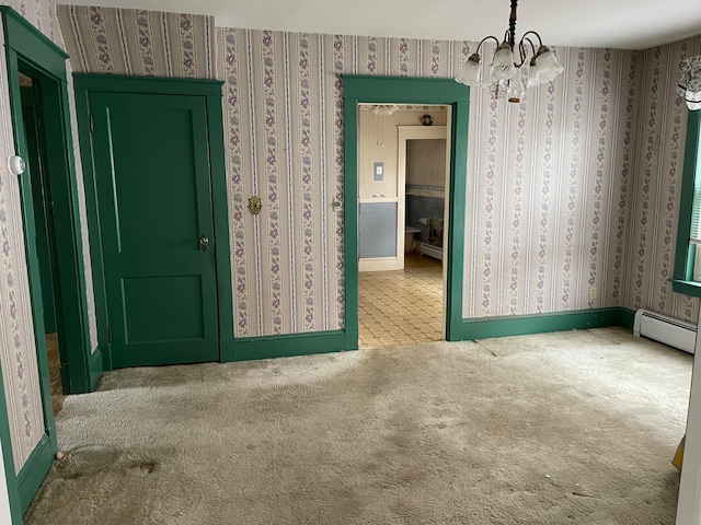 carpeted empty room with an inviting chandelier and a baseboard radiator