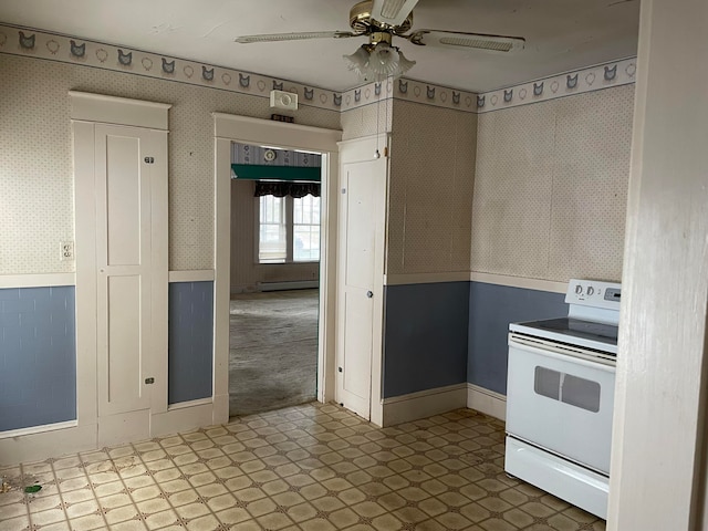 kitchen with ceiling fan, a baseboard heating unit, and white range with electric cooktop