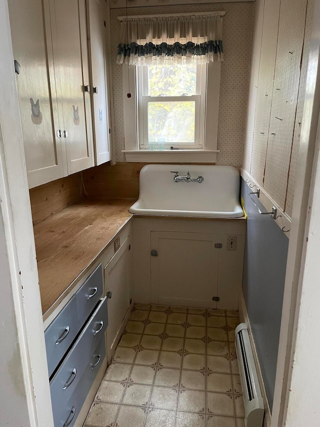 bathroom with sink and baseboard heating