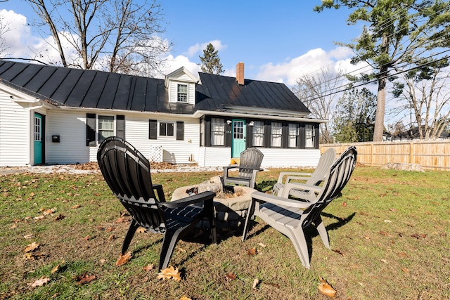 back of property featuring a lawn and a sunroom