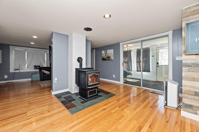 living room with a wood stove and hardwood / wood-style floors