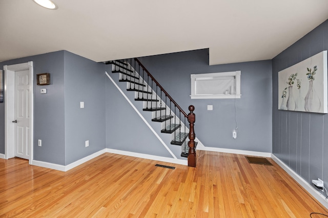 stairway with hardwood / wood-style flooring