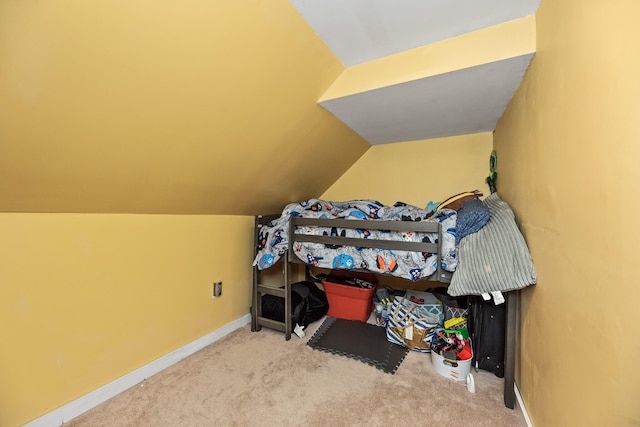 bedroom with lofted ceiling and carpet