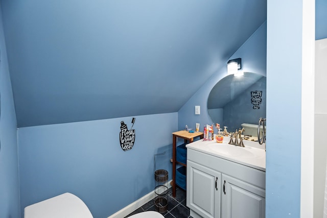 bathroom with vanity, toilet, and vaulted ceiling