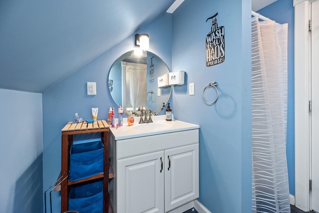 bathroom with vanity and lofted ceiling