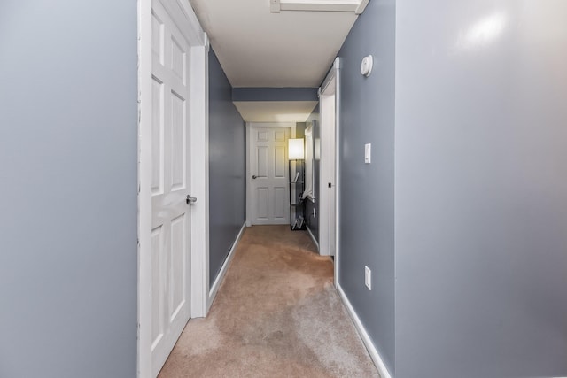 hall featuring light colored carpet