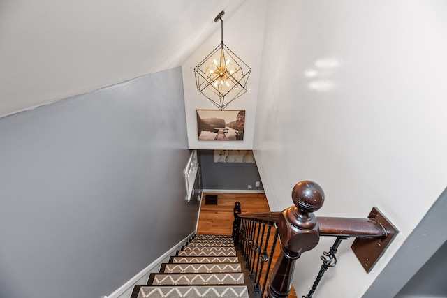 stairway with a chandelier