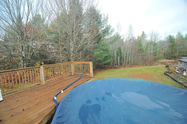 wooden terrace featuring a lawn