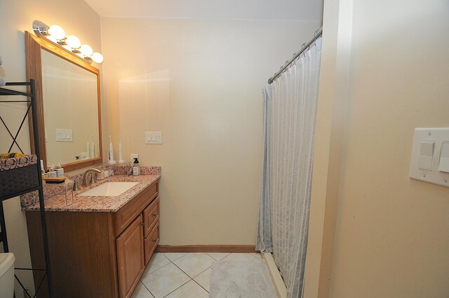 bathroom with vanity, a shower with shower curtain, and tile patterned flooring