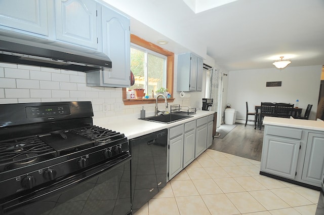 kitchen featuring light hardwood / wood-style floors, black appliances, sink, backsplash, and range hood