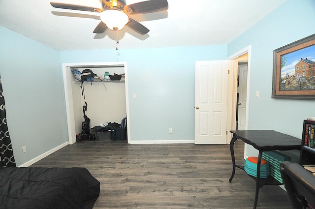 office with dark hardwood / wood-style flooring and ceiling fan