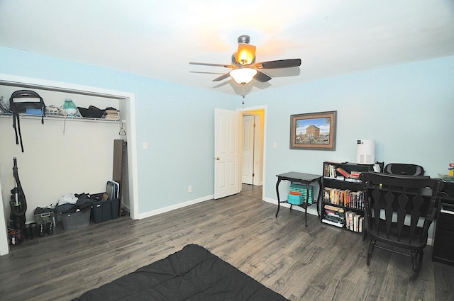 bedroom with dark hardwood / wood-style flooring and ceiling fan