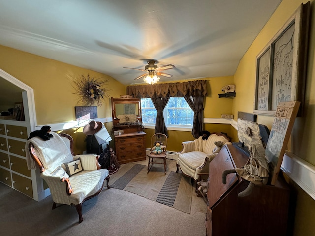 living area featuring ceiling fan, a baseboard radiator, vaulted ceiling, and carpet