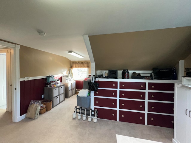 interior space featuring lofted ceiling and light carpet