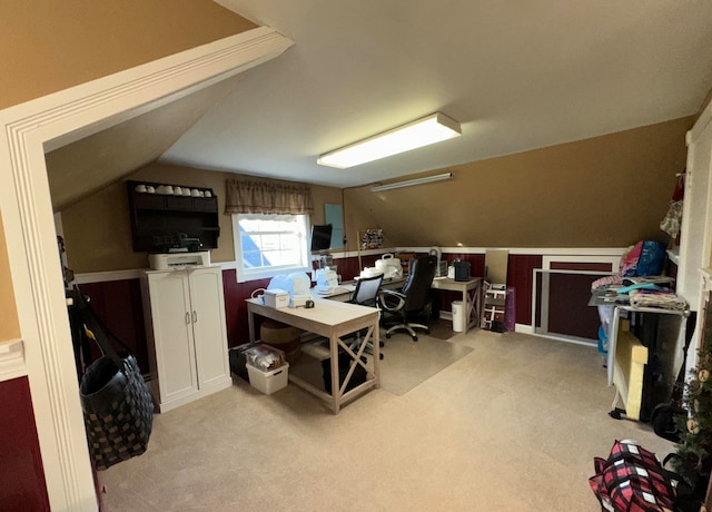 carpeted office with lofted ceiling