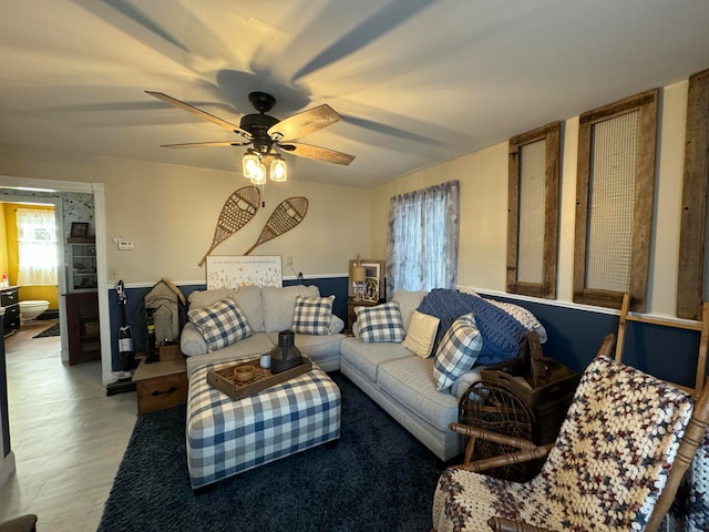 living room with ceiling fan and wood-type flooring