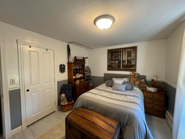 bedroom featuring a baseboard heating unit