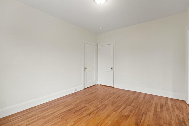 spare room featuring wood-type flooring