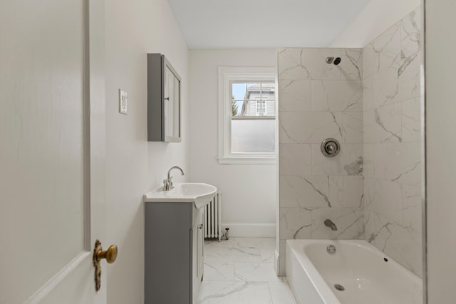 bathroom featuring radiator, tiled shower / bath combo, and vanity