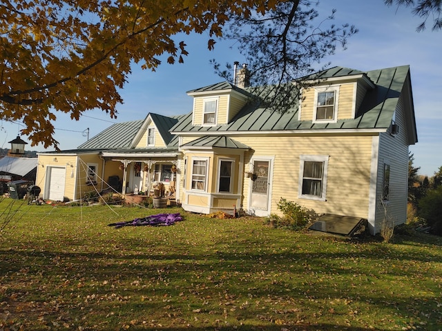 rear view of house with a yard