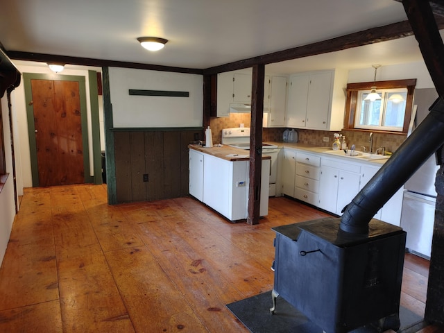 kitchen featuring white cabinetry, sink, backsplash, white range with electric cooktop, and hardwood / wood-style flooring