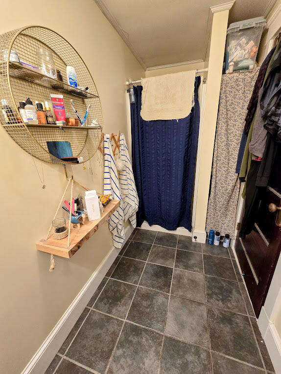 bathroom featuring tile patterned floors and ornamental molding