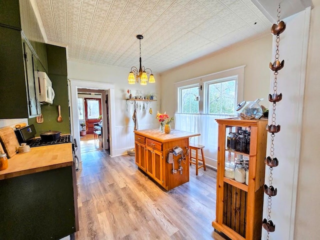 dining area with light wood-type flooring and a notable chandelier