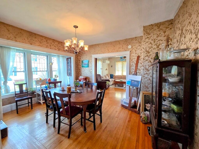 dining area featuring a notable chandelier and light hardwood / wood-style flooring